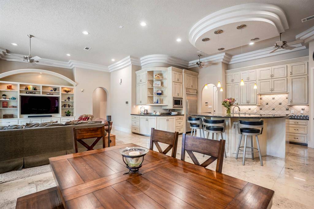 The family room, breakfast and kitchen have a wonderful flow, abundant custom built-ins are smartly designed for extensive storage.