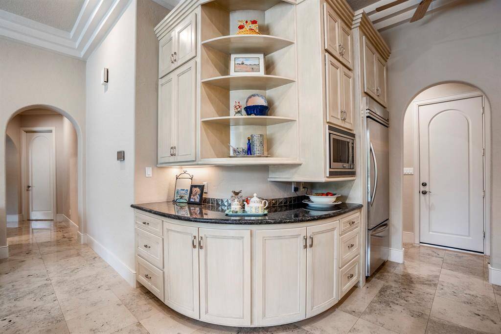 The kitchen area boasts a functional and stylish built-in cabinet, perfect for entertaining and everyday living.