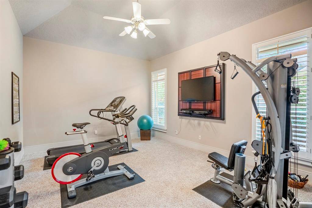 One of the secondary bedrooms is currently set up as a workout room, notice the plantation shutters and the size of this room!