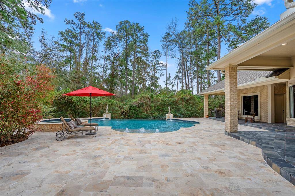 The pool was recently remodeled with new finish, new tile, new natural travertine decking in a Versailles pattern. Just to the right, we get a glimpse of the pool bath and 4th bedroom casita.