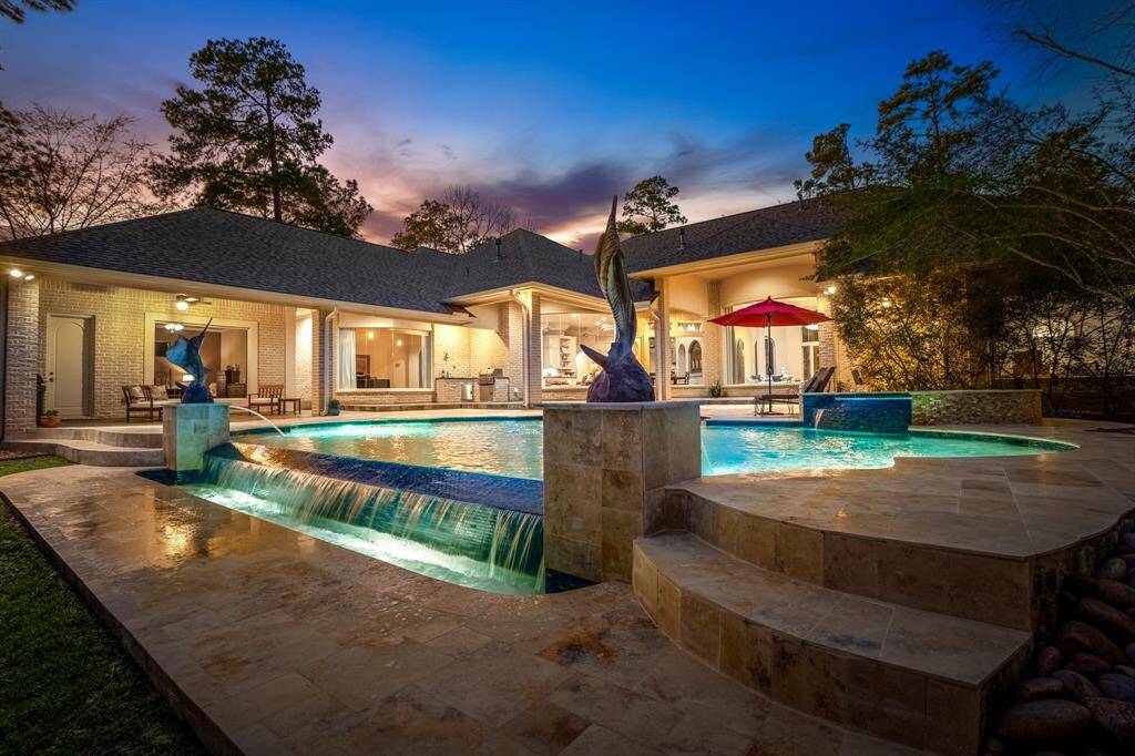 Evening views showcase the stunning blend between indoor and outdoor living, highlighting the classic beauty and timelss elegance of this home.