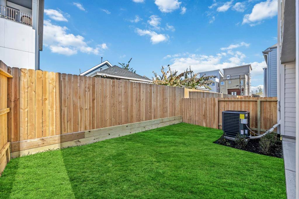 Private Backyard Oasis: A lush, green backyard offers the perfect spot for relaxation or outdoor fun, framed by a freshly installed privacy fence.