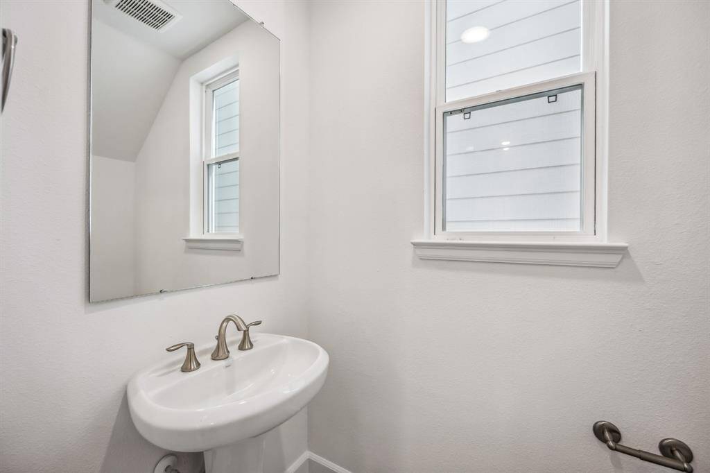 Elegant Simplicity: A thoughtfully designed powder room offers natural light, stylish finishes, and a welcoming atmosphere for guests.