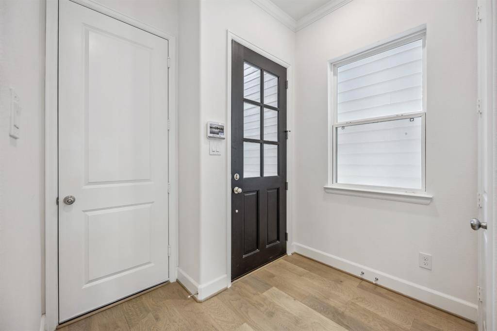 Convenient Entry: The mudroom-style entry features access to the attached garage and a stylish door leading to the backyard, blending practicality with elegance.