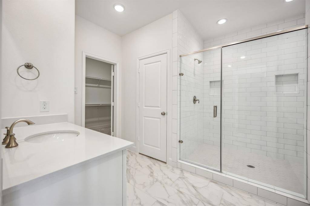 Shower in Style: Revel in the expansiveness of a large shower, standard with sleek finishes and dual shower heads, providing plenty of space for shared morning routines.