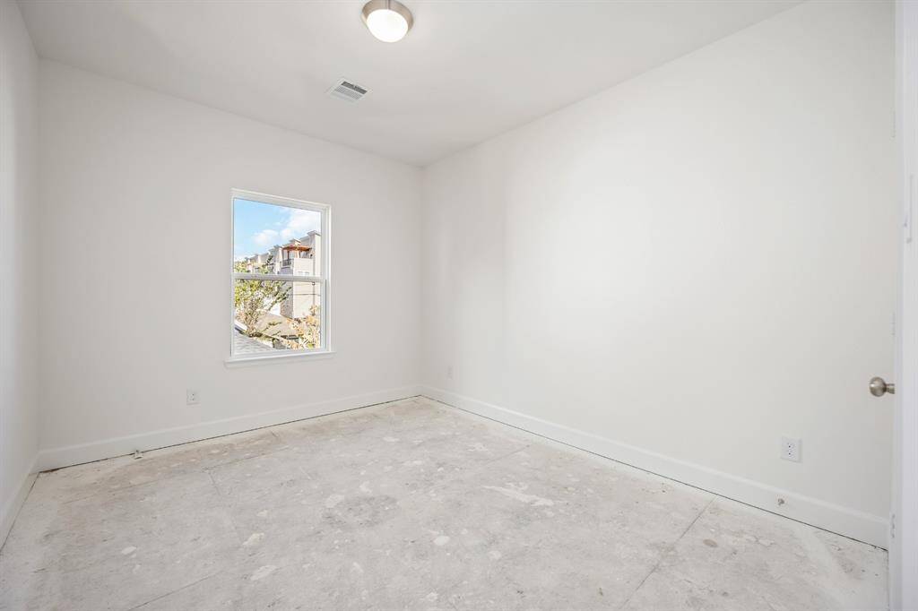 Secondary Bedroom Serenity: A bright and versatile secondary bedroom with plush carpeting and natural light, perfect for guests or an additional home office.