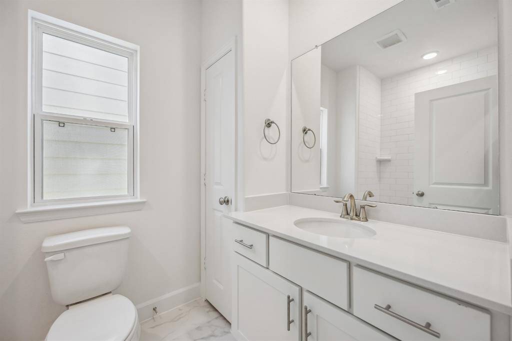 Graceful Convenience: The hall bathroom serves as an oasis of elegance and practicality, thoughtfully equipped to cater to both guests and family with stylish fixtures and serene finishes.