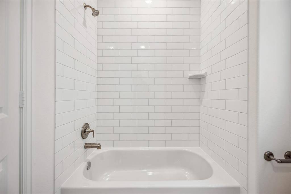 Sleek Bath Design: A hall bathroom showcasing modern subway tile and polished fixtures, combining timeless design with everyday functionality.
