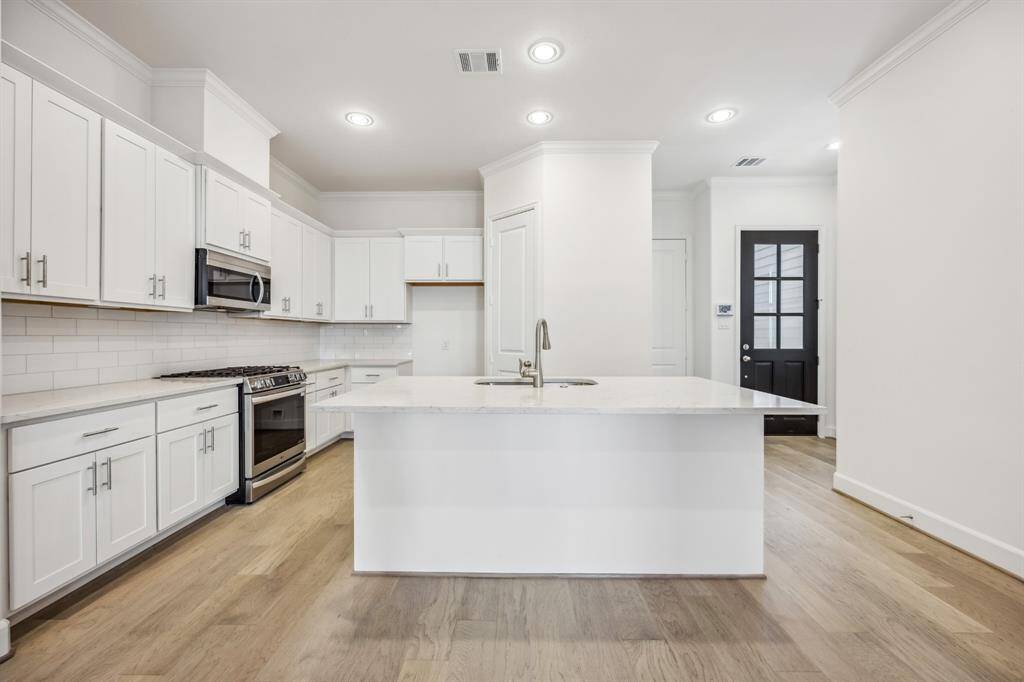 Culinary Paradise: A chef's dream kitchen awaits, featuring direct garage access for seamless transitions from car to culinary creation.