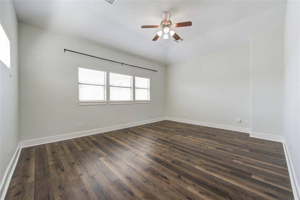 This expansive third-floor primary suite is a true retreat, featuring durable and stylish LVT flooring that adds warmth and modern appeal.