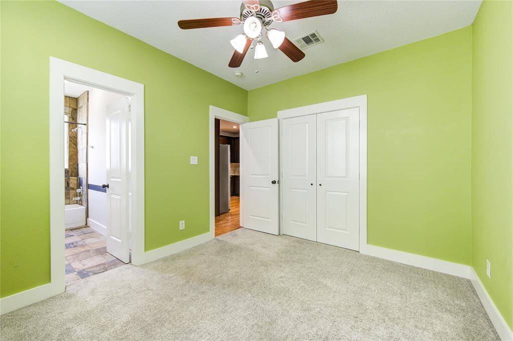 Located on the third floor, this generously sized third bedroom offers plush carpeting and large windows that bring in abundant natural light. The en-suite bathroom adds privacy and convenience, making this space ideal for a roommate floorplan or guests.