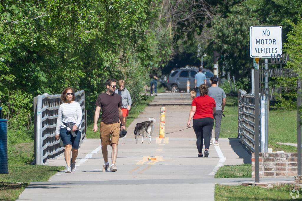 Residents enjoy leisurely strolls along White Oak Bayou Greenway, soaking in nature.