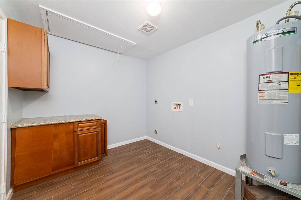 Utility room beside the living area. Extra cabinetry added for convenience!