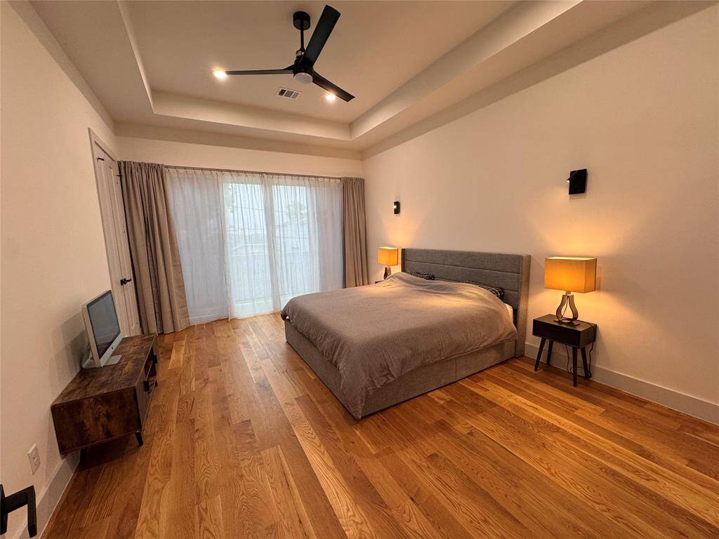 Primary bedroom over the garage with its own tiled balcony.