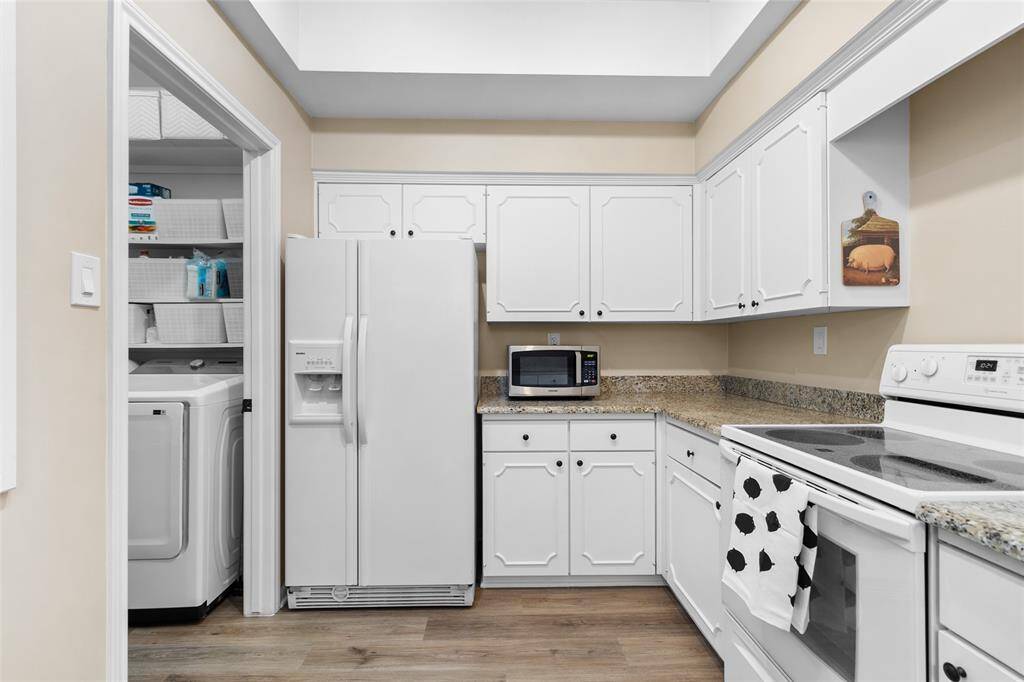 Updated kitchen with granite countertops and easy access to Laundry room