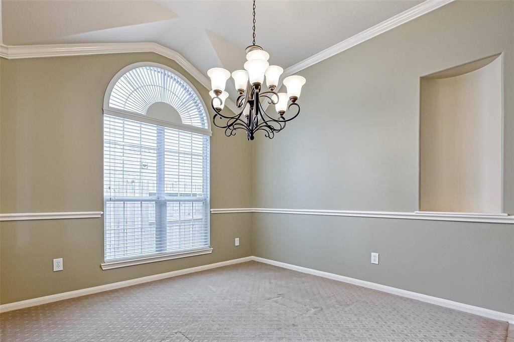 Dining Room sports an arched top window and chandelier.