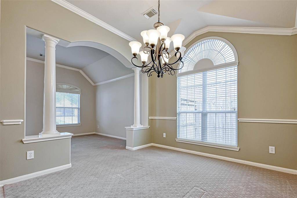 Dining Room sports an arched top window and chandelier.