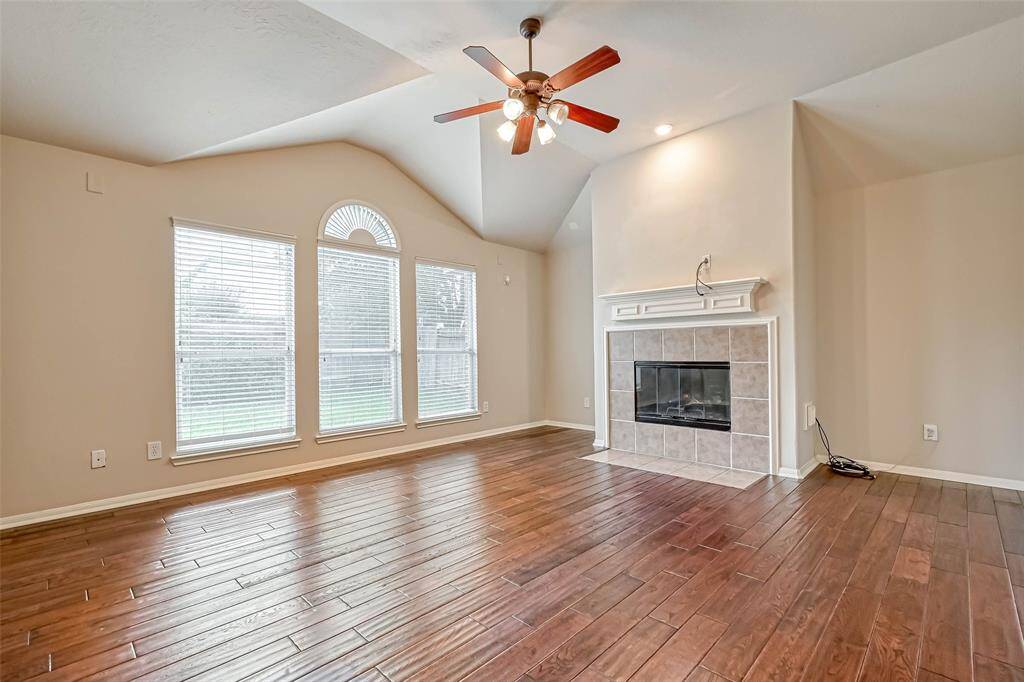 Family Room offers plenty of natural light, wood flooring and a gas fireplace.