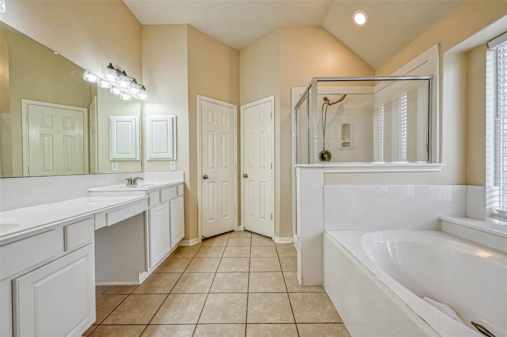 Primary Bath features a tub with separate shower