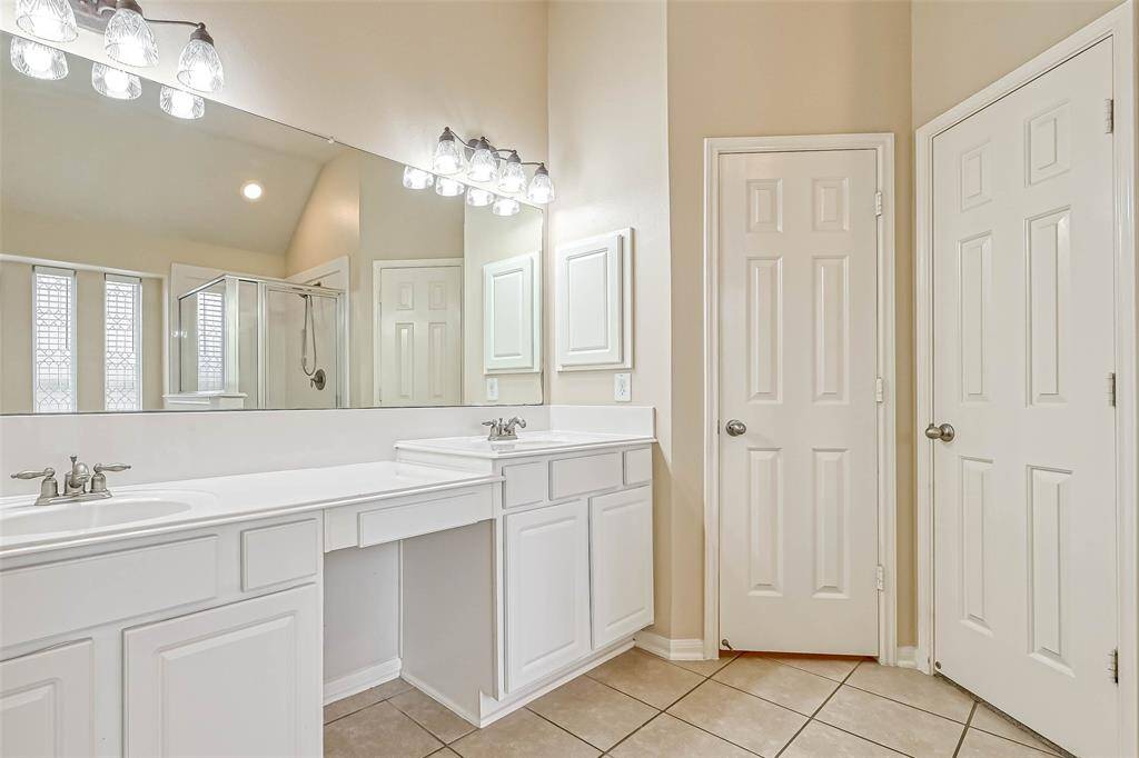 Primary Bath has a large mirror and a knee space for applying make-up.