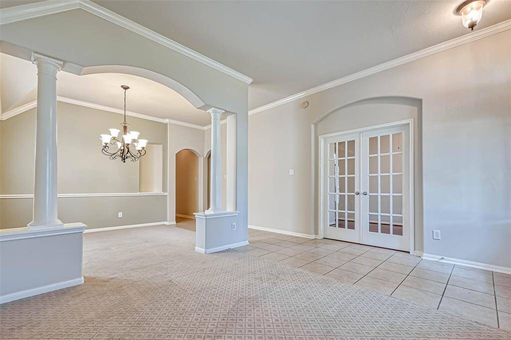 Living Room looking at Dining Room through the arched opening and at the double doors to the bedroom/study/home office.