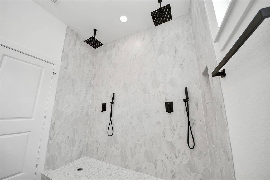 The shower of your dreams! A built in soap niche, dual rainfall shower heads and dual handheld shower heads too!