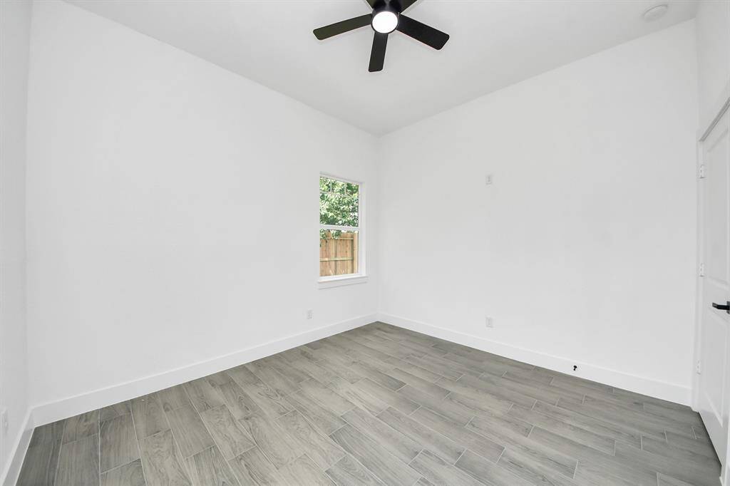 Secondary bedroom #1, complete with a ceiling fan and spacious closet.