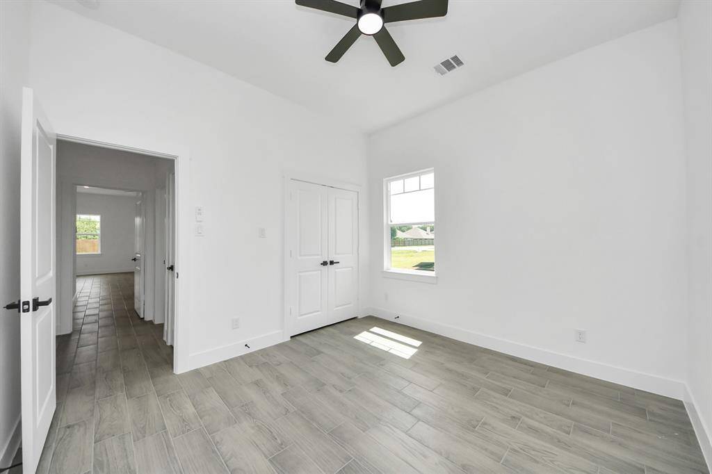 Bedroom #3, with the same wood-look tile throughout the rest of the house!