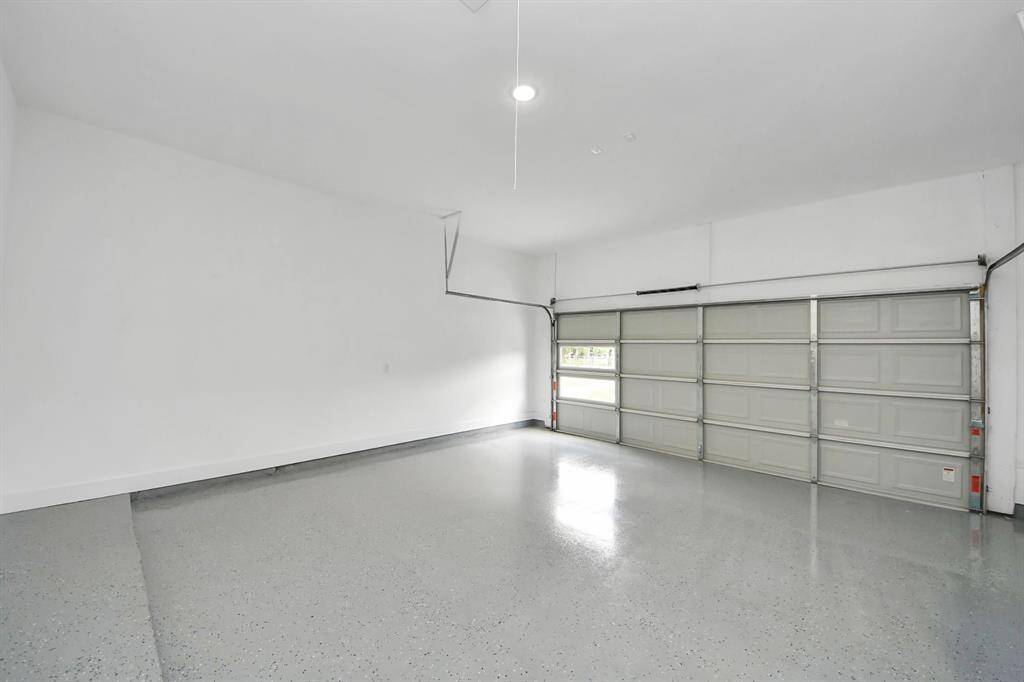 Spacious two-car garage with sleek epoxy floor—move-in ready with plenty of room for storage or projects.