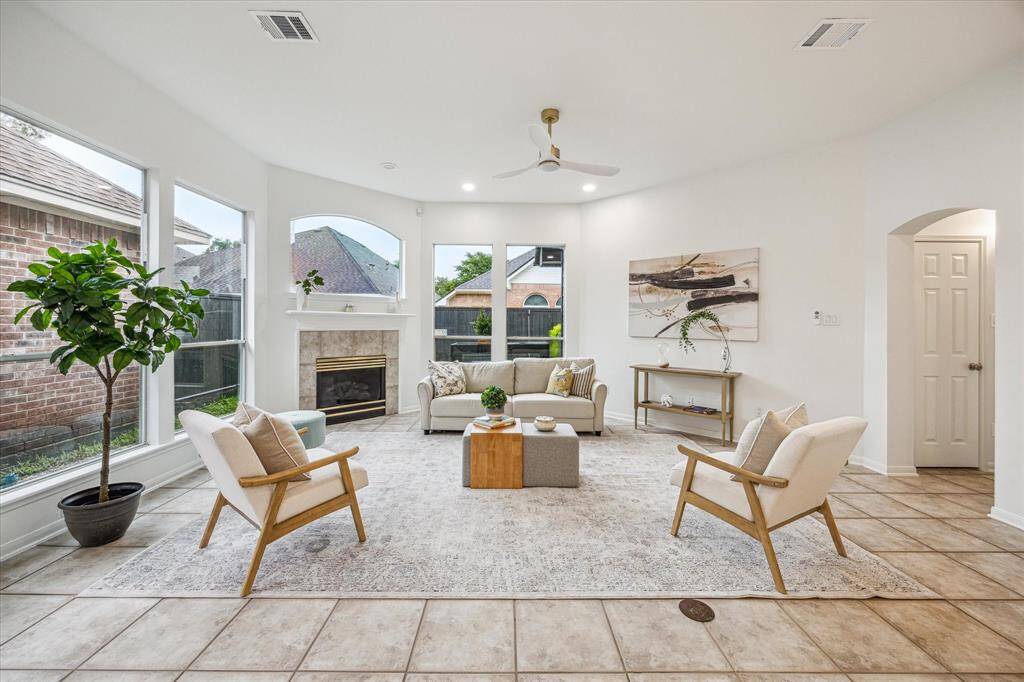 The family room offers panoramic floor to ceiling windows!  Light and bright even on a cloudy day.  Fireplace is remote operated gas log.