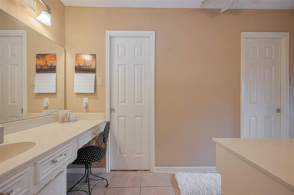 primary bathroom with 2 doors with his and her closets