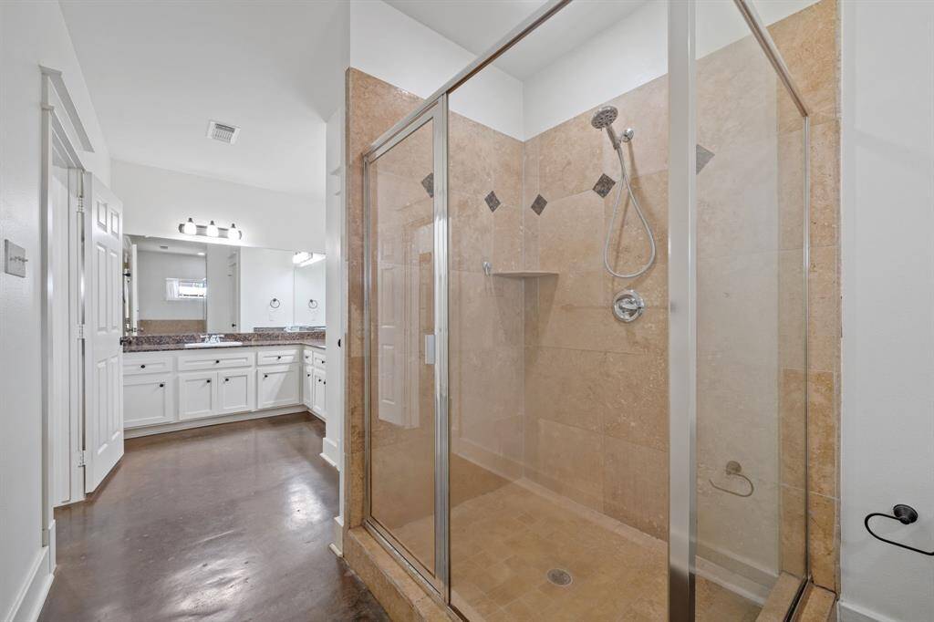 This beautiful Primary Bathroom features a spacious glass enclosed shower with gorgeous tiling!