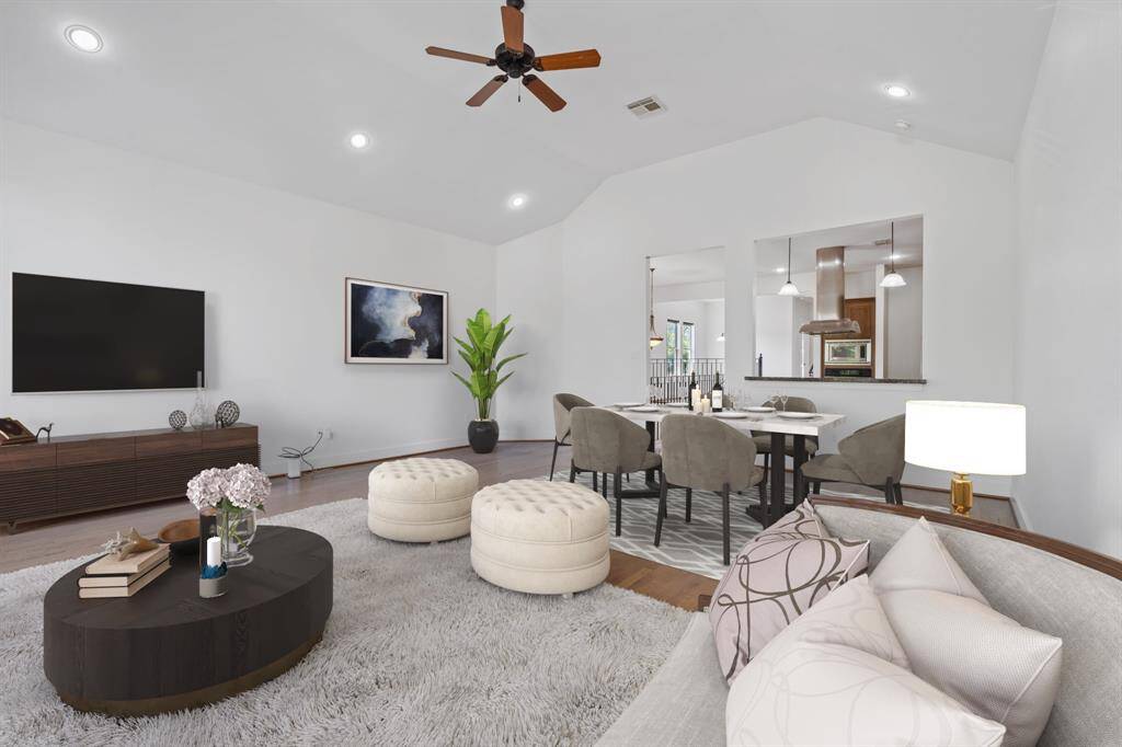 Virtually Staged: This gorgeous living room features hardwood flooring, recessed lighting, and high ceilings with a fan!