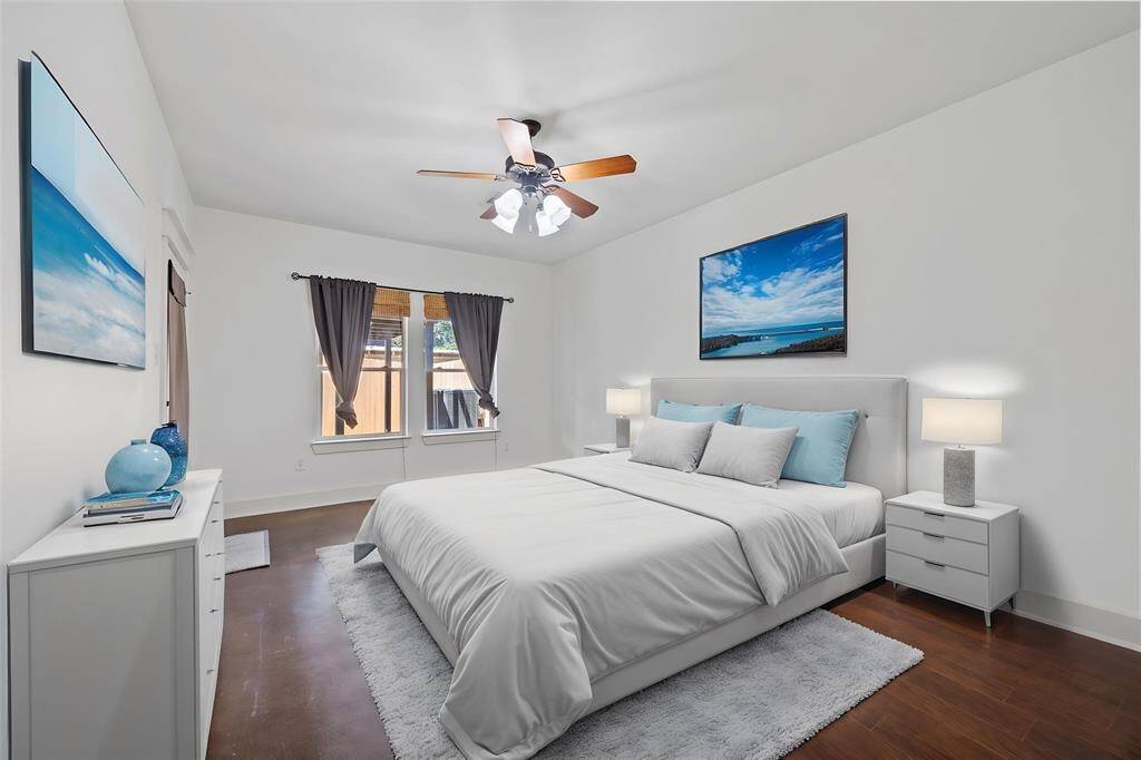 Virtually Staged: Unwind after a long day in this incredibly Master Suite! Featuring hardwood floors, a ceiling fan, and large windows that provide plenty of light throughout the day.