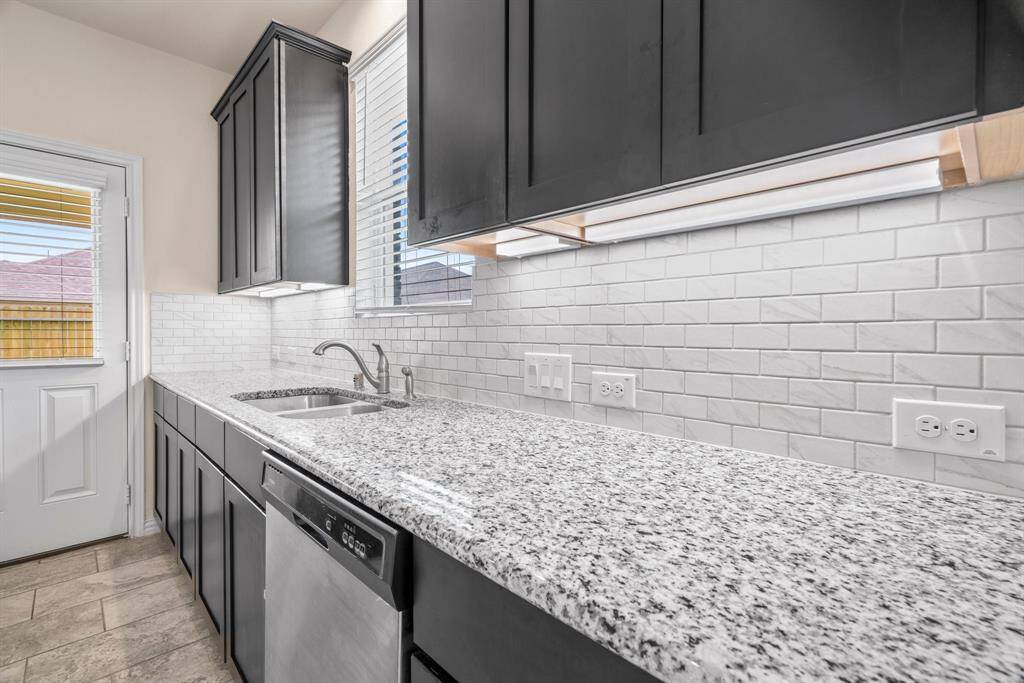 This spacious, well-lit room features large windows, neutral walls, and tile flooring, creating a versatile space perfect for a living or dining area.