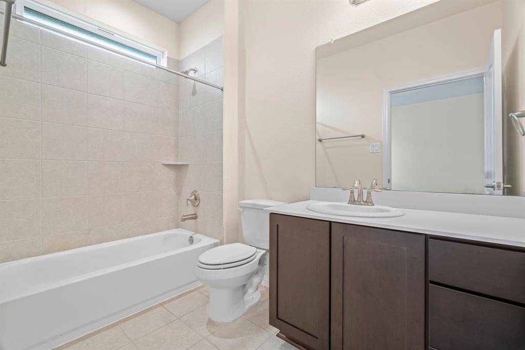 Modern shower with sleek, light-toned tiles, a built-in bench, and a glass door, offering a clean and elegant look with a BENCH!