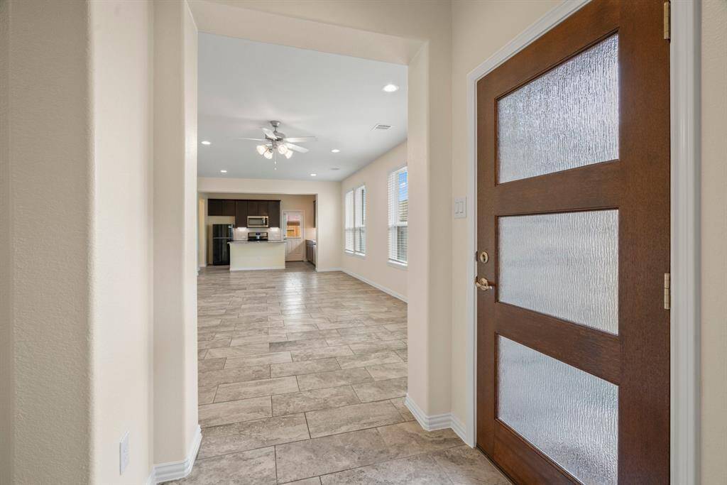 Sierra Vista neighborhood with modern brick houses, each featuring a two-car garage and neatly maintained lawns. The homes are evenly spaced, offering privacy with fenced backyards. The area looks peaceful and well-planned, ideal for family living.