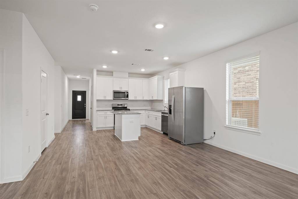 The dining area, conveniently located next to the kitchen and living room, offers plenty of space for a large table—perfect for family meals and gatherings!