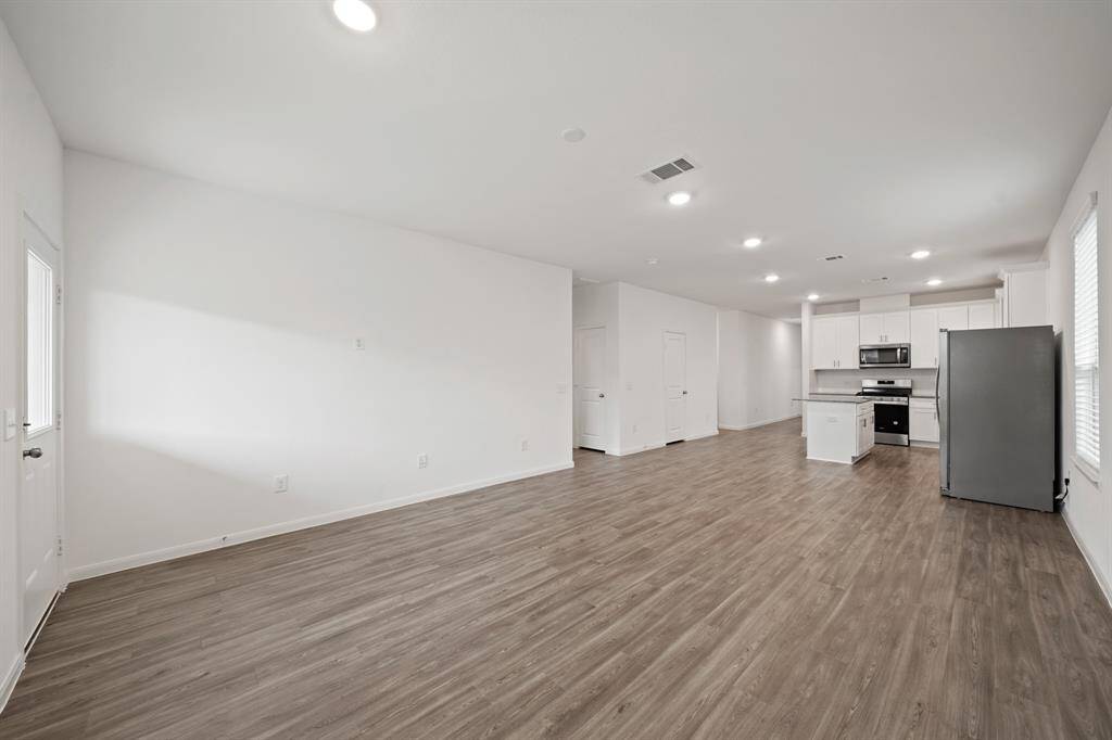 Spacious open-concept design seamlessly connects the kitchen, dining, and living areas, creating an ideal layout for both everyday living and entertaining.