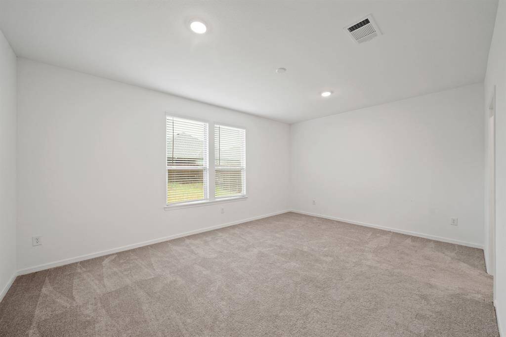 How perfect is this primary suite? Spacious and filled with natural light, this serene retreat offers the ultimate escape, promising comfort, tranquility, and pure relaxation.