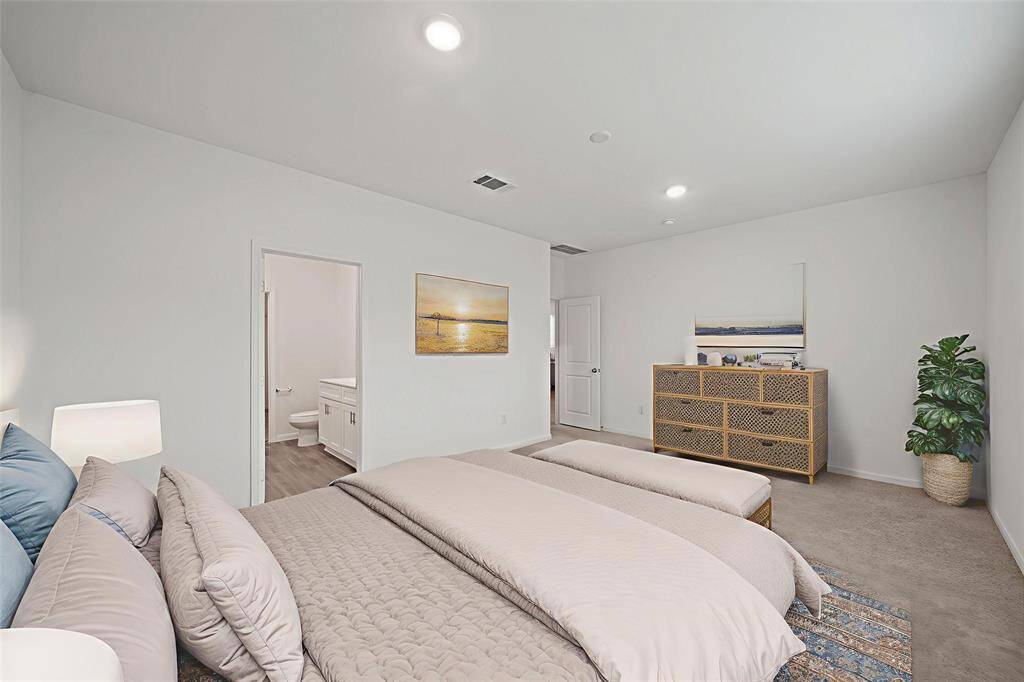 The spacious primary bedroom flows into a private en-suite bath, offering a serene retreat all your own. - virtually staged