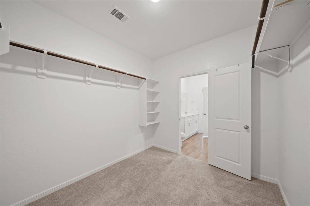 The primary closet offers ample space to store all your clothes and keep everything organized.
