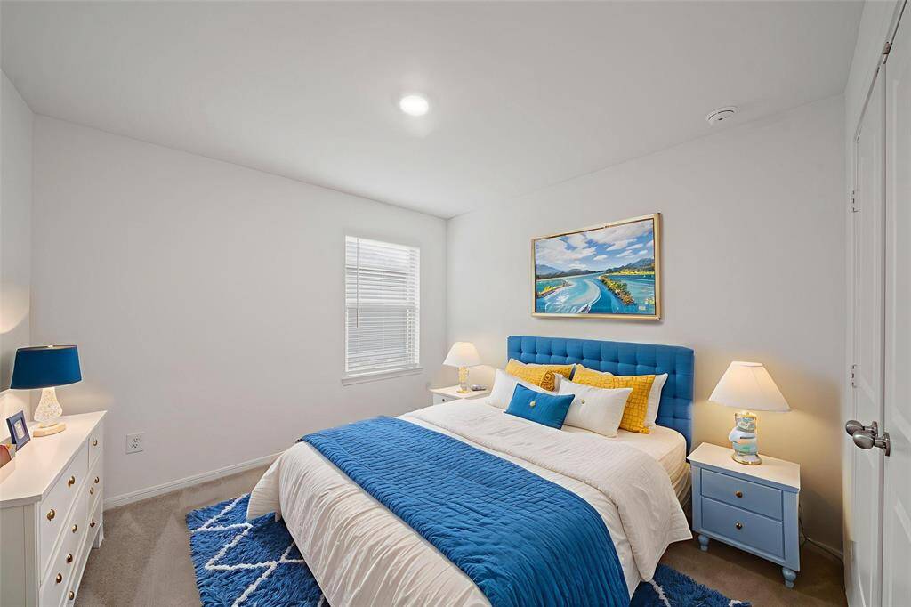 Here is your spacious second bedroom, offering comfort for family or guests. - virtually staged