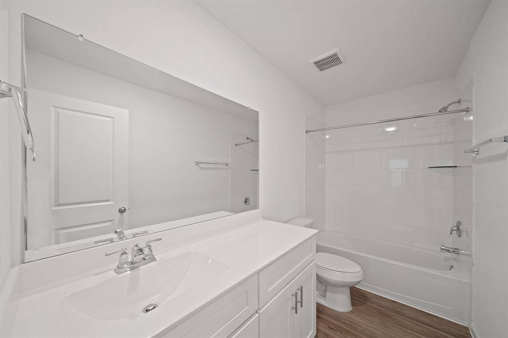The secondary bathroom is stylishly appointed and thoughtfully designed for comfort and convenience.