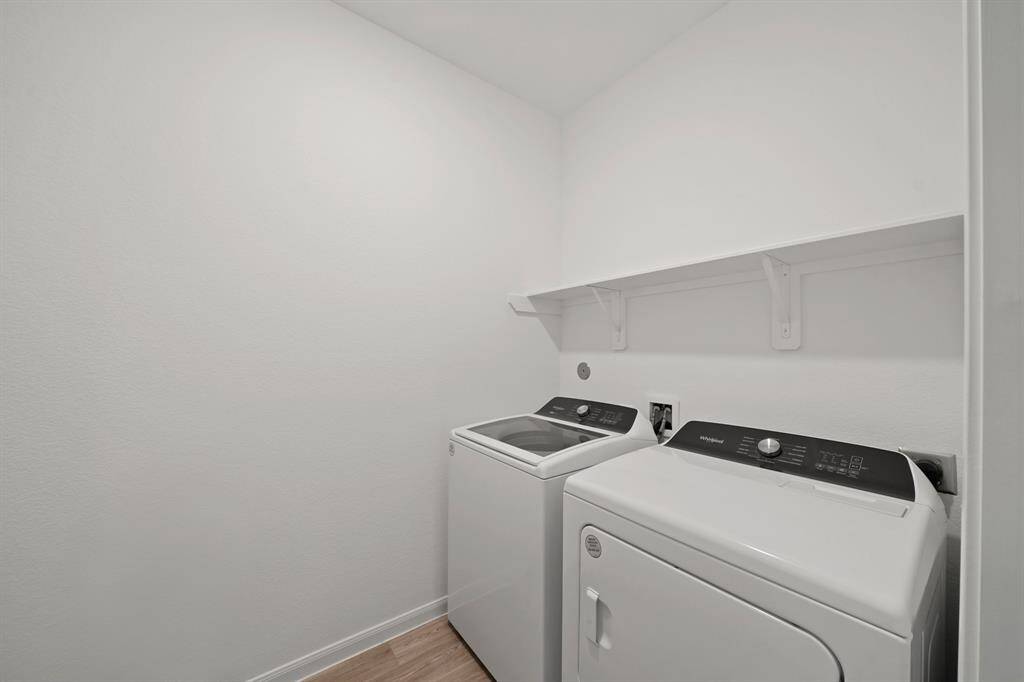 Convenient and organized, this dedicated laundry space makes daily chores a breeze!