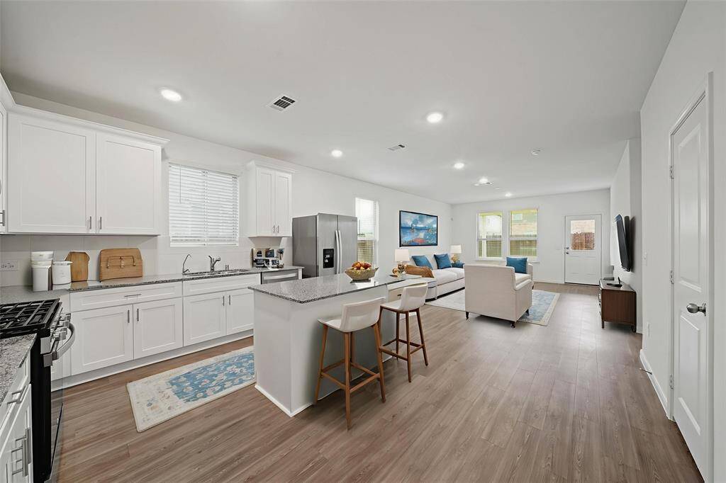 Get ready to impress in your chef-inspired kitchen! This open-concept layout seamlessly blends the kitchen, dining, and living areas into a delightful space perfect for entertaining and everyday living. - virtually staged
