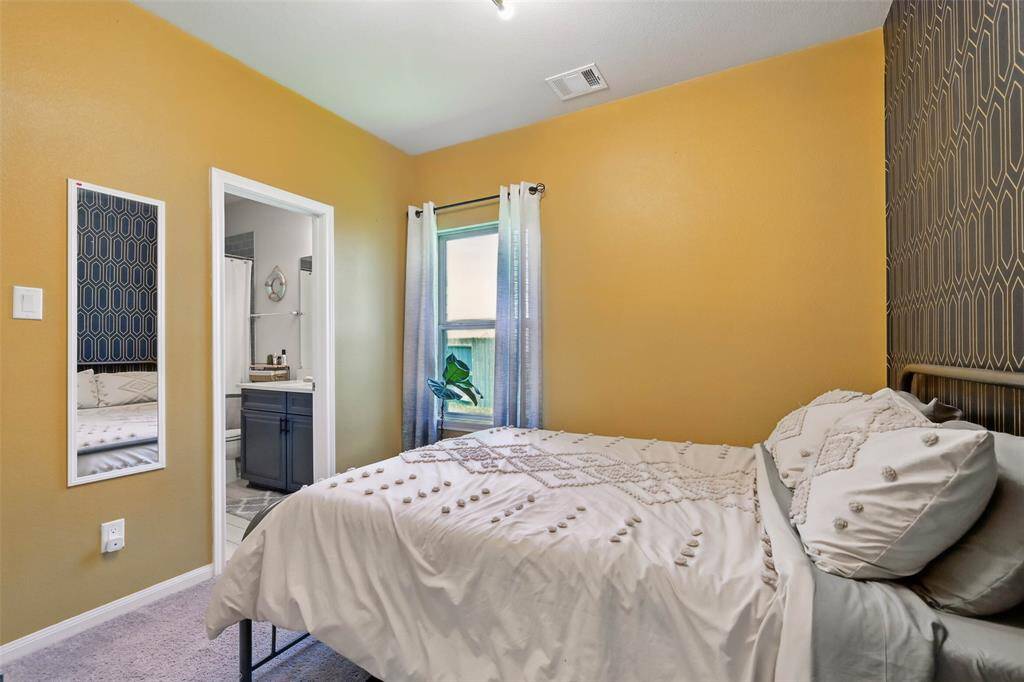 Bedroom 2 located on the first floor features a private en-suite bath
