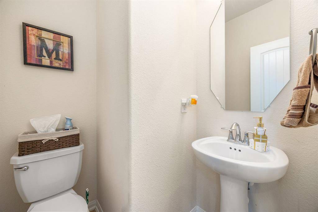 Half powder room located downstairs off the family room