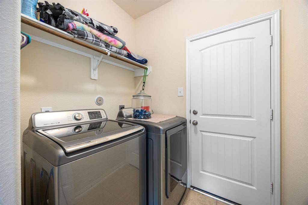 Walk in laundry room with garage access