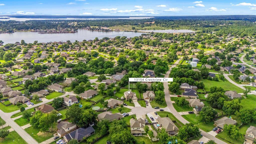 Amazing aerial shot of this beautiful home situated on a cul-de-sac in the sought-after community of Lake Conroe Hills. The community offers a boat ramp with access to Lake Conroe.